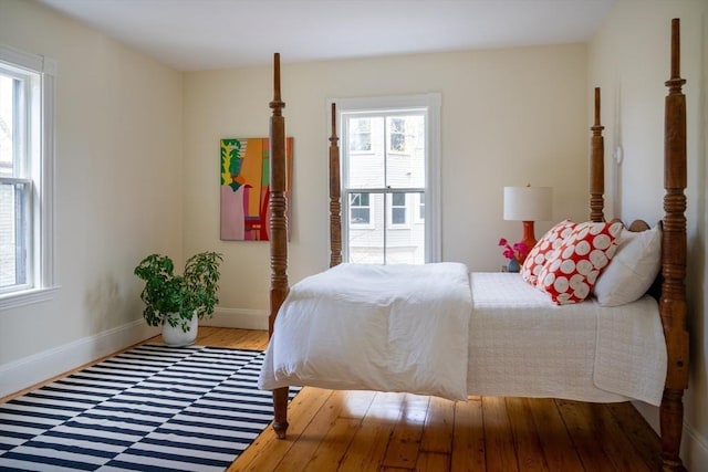 bedroom featuring baseboards and wood finished floors