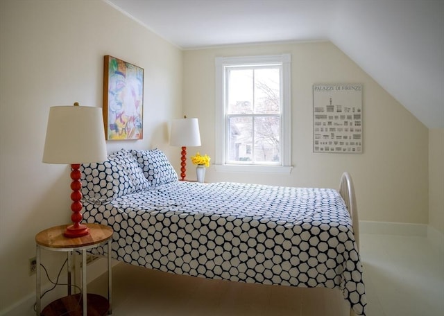 bedroom featuring baseboards and lofted ceiling