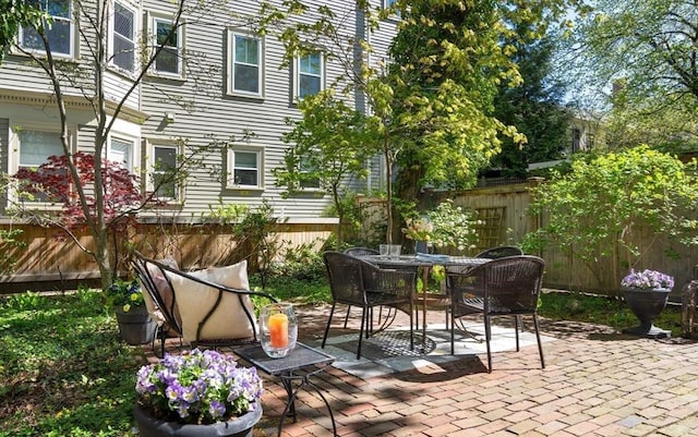 view of patio featuring fence and outdoor dining space