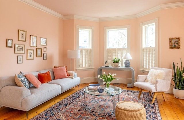 sitting room with baseboards, ornamental molding, and hardwood / wood-style flooring