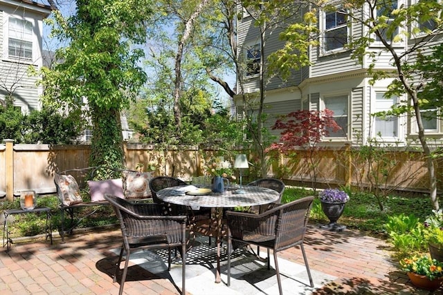 view of patio featuring fence and outdoor dining space