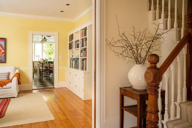 interior space with stairway, ornamental molding, and hardwood / wood-style floors