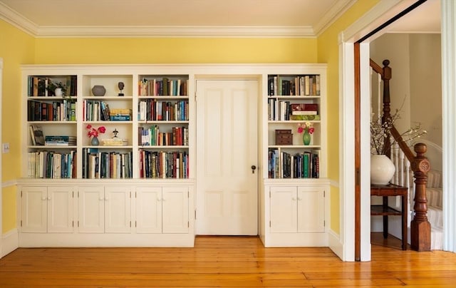 unfurnished room featuring ornamental molding and light wood-type flooring