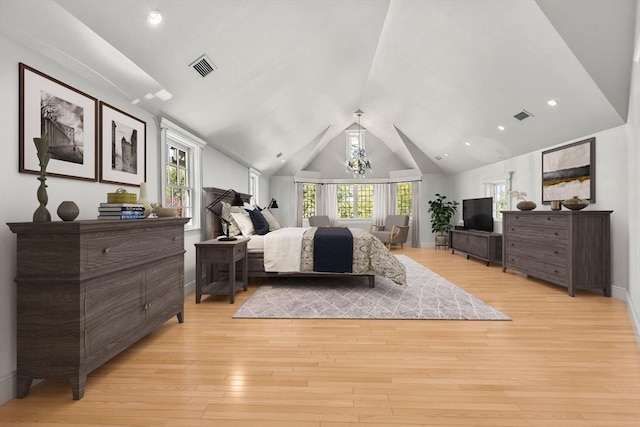 bedroom featuring vaulted ceiling, multiple windows, light wood-type flooring, and baseboards