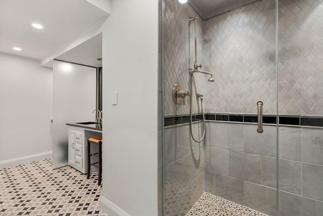 full bath featuring baseboards, a stall shower, vanity, and recessed lighting