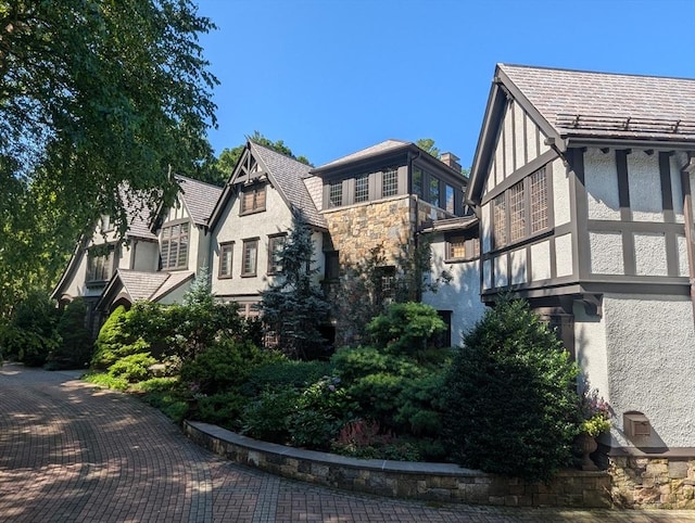view of home's exterior with stucco siding and stone siding