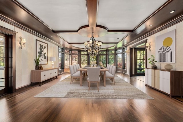 dining area featuring crown molding, a chandelier, wood finished floors, and baseboards