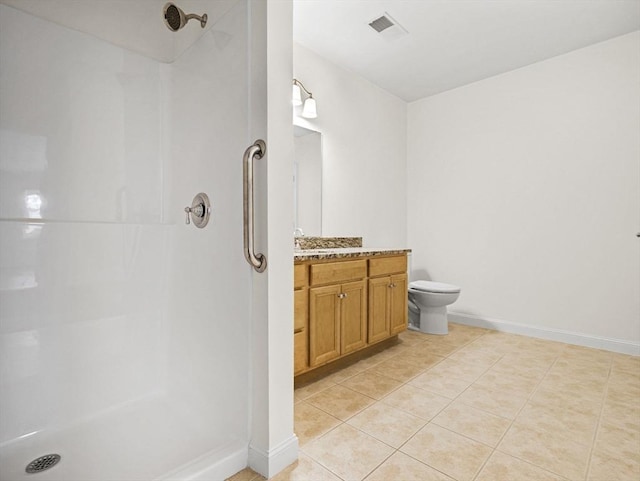 bathroom with vanity, tile patterned floors, walk in shower, and toilet