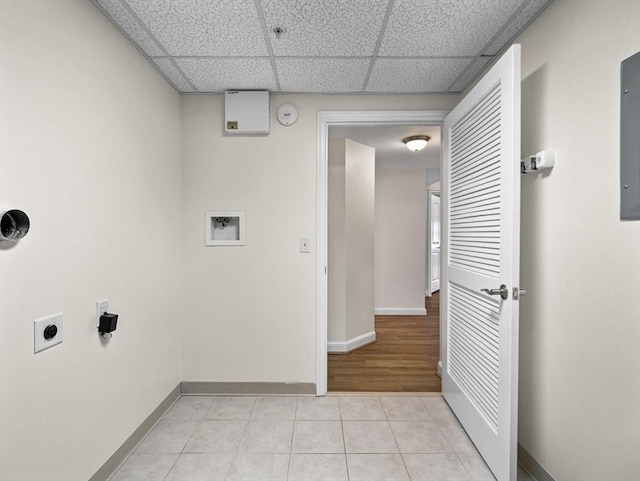 laundry room featuring baseboards, hookup for a washing machine, light tile patterned floors, and hookup for an electric dryer