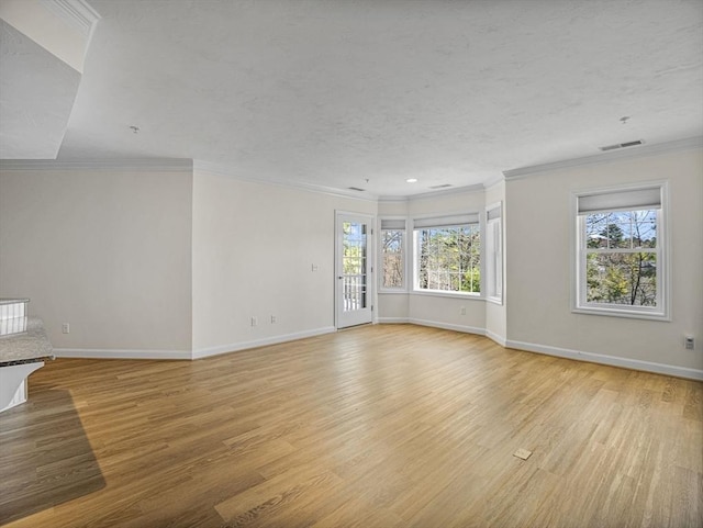 unfurnished living room featuring baseboards, visible vents, and light wood-style flooring