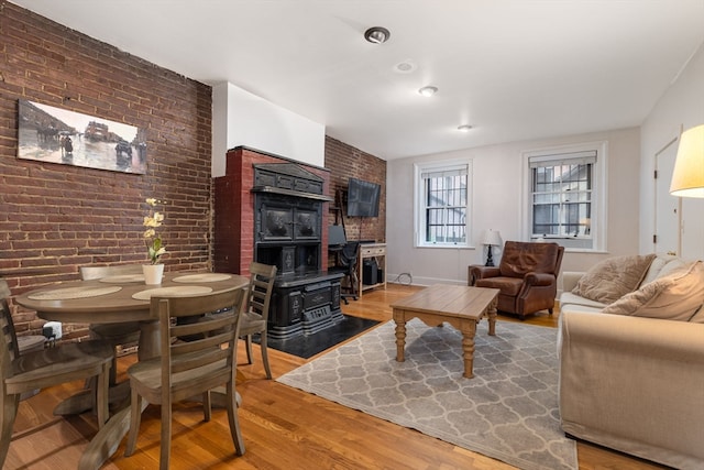 living room with wood-type flooring and brick wall