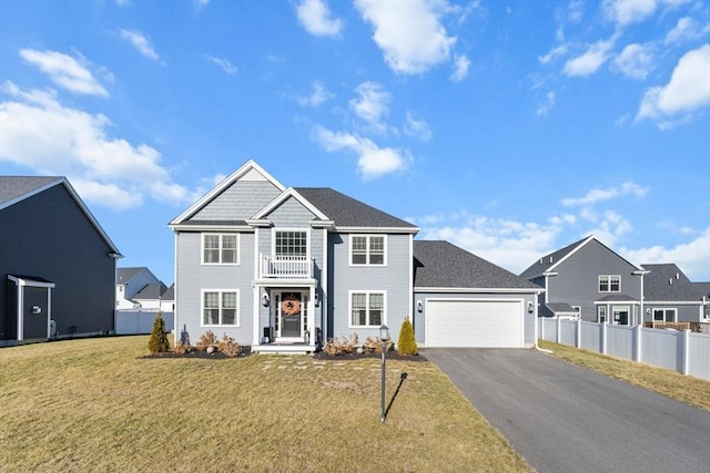 view of front of house featuring a garage, a balcony, and a front lawn