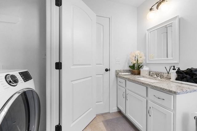 interior space with tile patterned flooring, washer / dryer, and vanity