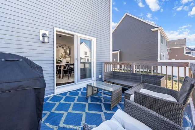 wooden terrace featuring outdoor lounge area and a grill