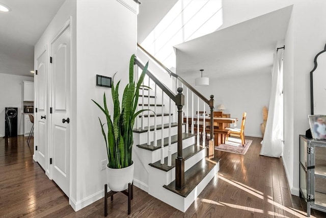 stairs featuring hardwood / wood-style flooring