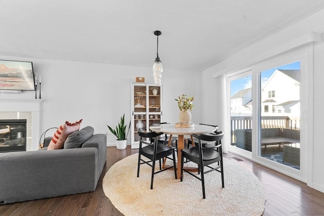 dining space with dark hardwood / wood-style floors