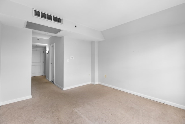 unfurnished room featuring light colored carpet and vaulted ceiling