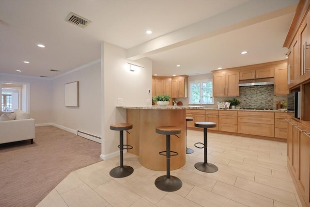5 Taintor Dr, Sudbury, MA 01776 - kitchen with a breakfast bar, black stovetop, a baseboard heating unit, backsplash, and recessed lighting