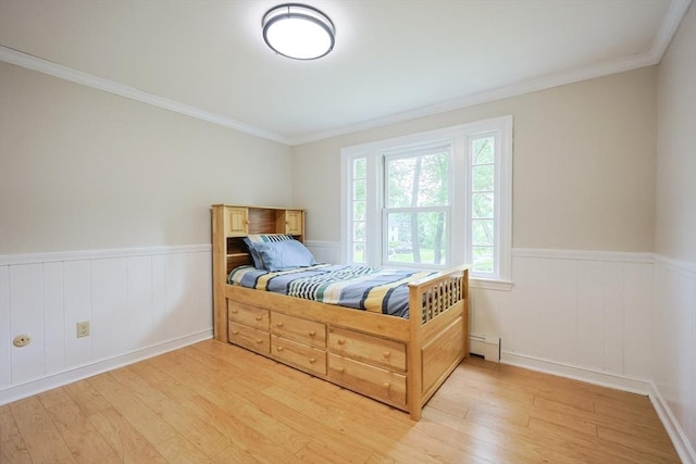 5 Taintor Dr, Sudbury, MA 01776 - bedroom featuring a baseboard radiator, light wood-type flooring, a wainscoted wall, and crown molding