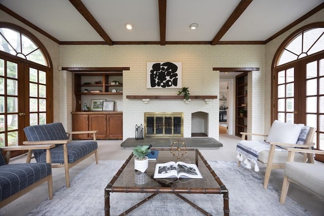 5 Taintor Dr, Sudbury, MA 01776 - living room with french doors, plenty of natural light, a brick fireplace, and beam ceiling