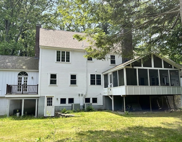 5 Taintor Dr, Sudbury, MA 01776 - rear view of house featuring a sunroom, a chimney, cooling unit, and a yard