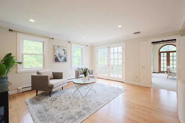 5 Taintor Dr, Sudbury, MA 01776 - living area with french doors, ornamental molding, a baseboard heating unit, light wood-style floors, and baseboards