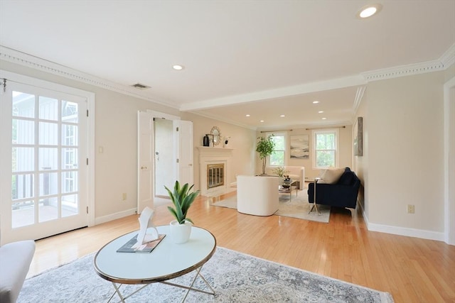 5 Taintor Dr, Sudbury, MA 01776 - living area featuring light wood-style flooring, a fireplace with flush hearth, crown molding, baseboards, and recessed lighting