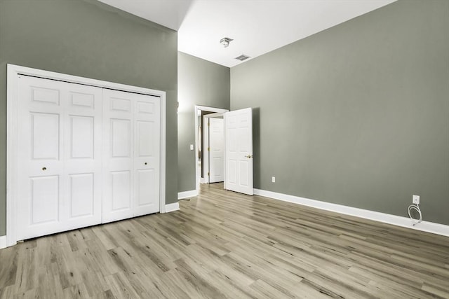 31-33 Ashland St Unit 3, Haverhill, MA 01830 - unfurnished bedroom with wood finished floors, baseboards, a closet, and a high ceiling