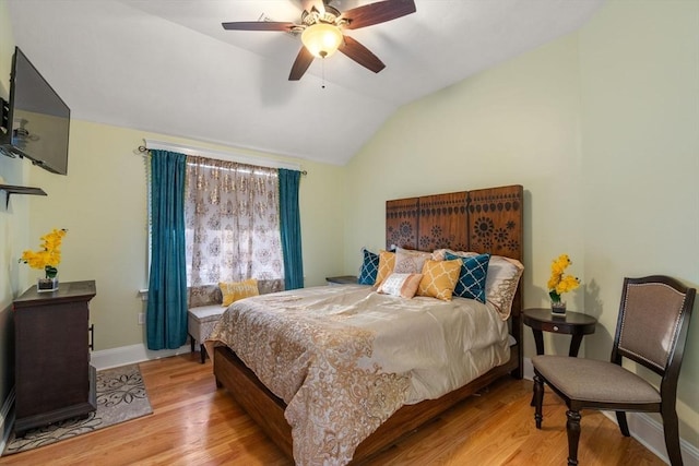 bedroom with vaulted ceiling, light hardwood / wood-style floors, and ceiling fan