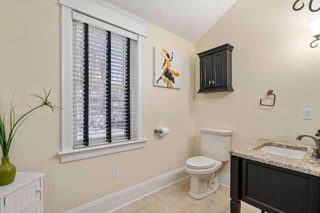 bathroom featuring vanity, tile patterned flooring, a wealth of natural light, and toilet