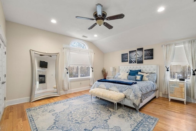 bedroom featuring lofted ceiling, hardwood / wood-style floors, and ceiling fan