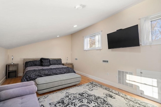 bedroom featuring lofted ceiling and light wood-type flooring