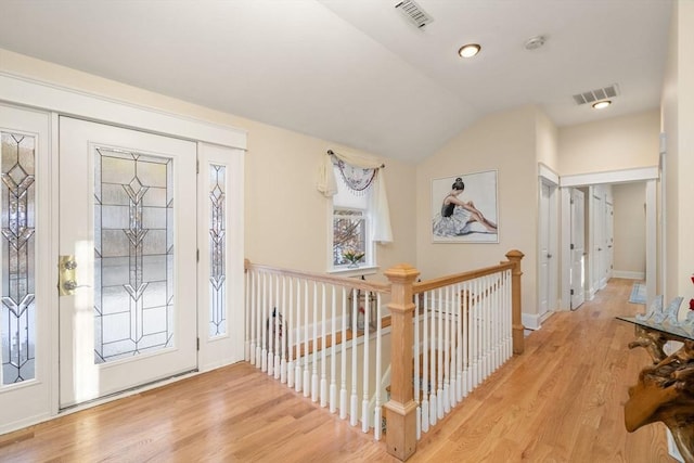 foyer entrance featuring light hardwood / wood-style flooring and vaulted ceiling