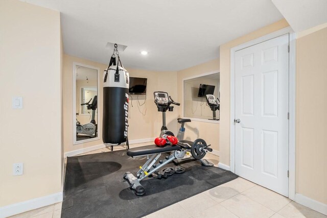 exercise area featuring tile patterned floors, recessed lighting, and baseboards