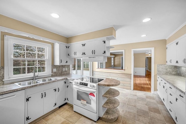 kitchen with white appliances, white cabinets, light countertops, open shelves, and a sink