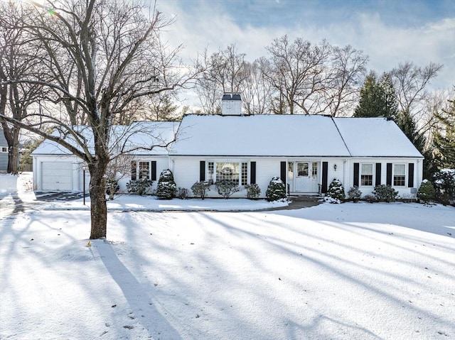 single story home featuring a chimney and a detached garage