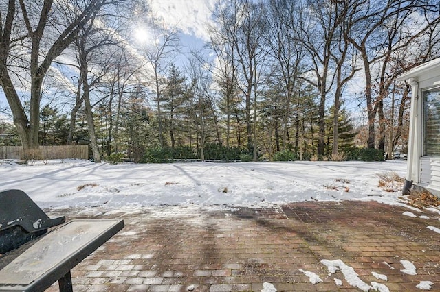 yard covered in snow featuring fence