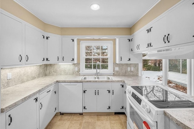 kitchen with light countertops, white appliances, a sink, and under cabinet range hood