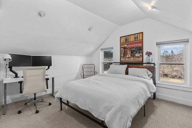 bedroom featuring carpet, vaulted ceiling, and multiple windows