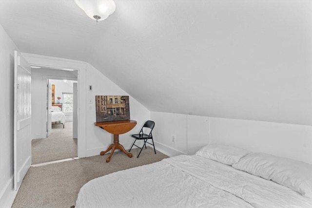 carpeted bedroom with vaulted ceiling