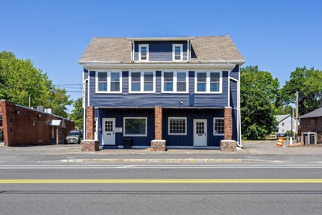 318 Newton St, South Hadley, MA 01075 - view of front facade with board and batten siding, covered porch, and central AC unit