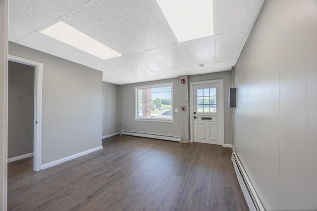 318 Newton St, South Hadley, MA 01075 - spare room with baseboard heating, a drop ceiling, dark wood finished floors, and baseboards
