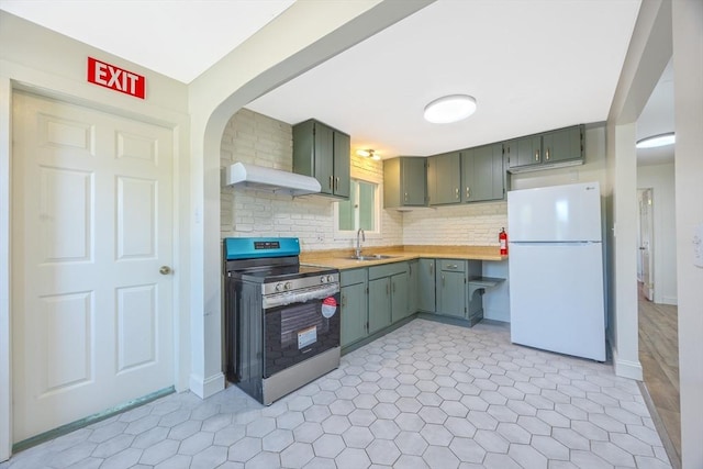 318 Newton St, South Hadley, MA 01075 - kitchen with stainless steel electric range oven, freestanding refrigerator, under cabinet range hood, light countertops, and a sink