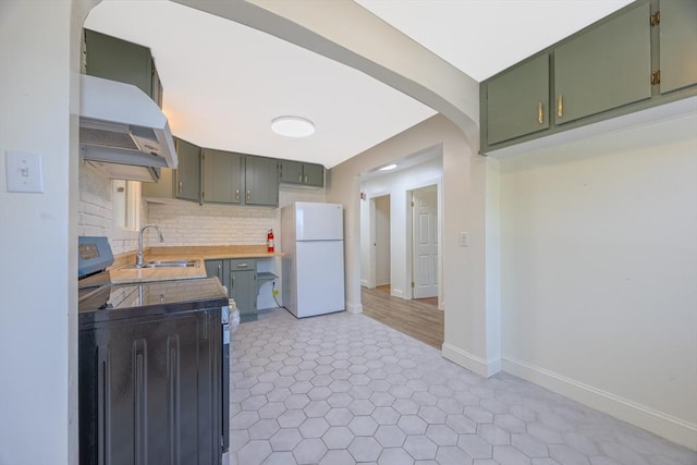 318 Newton St, South Hadley, MA 01075 - kitchen featuring freestanding refrigerator, stainless steel range with electric cooktop, green cabinetry, exhaust hood, and a sink