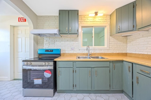 318 Newton St, South Hadley, MA 01075 - kitchen featuring electric range, a sink, range hood, light countertops, and light tile patterned floors