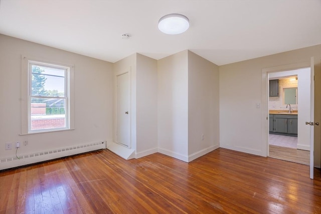 318 Newton St, South Hadley, MA 01075 - empty room with hardwood / wood-style floors, a baseboard radiator, baseboards, a sink, and a smoke detector