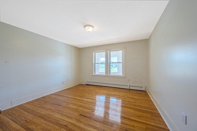 318 Newton St, South Hadley, MA 01075 - empty room featuring a baseboard radiator, wood finished floors, and baseboards