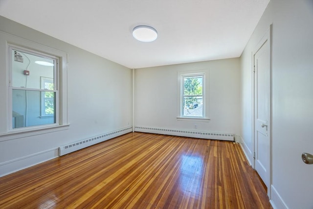 318 Newton St, South Hadley, MA 01075 - unfurnished bedroom featuring baseboard heating, a baseboard heating unit, hardwood / wood-style flooring, and baseboards