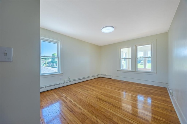318 Newton St, South Hadley, MA 01075 - spare room featuring hardwood / wood-style flooring, a baseboard heating unit, and baseboards