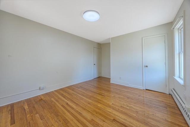 318 Newton St, South Hadley, MA 01075 - unfurnished bedroom with a baseboard radiator, light wood-type flooring, and baseboards